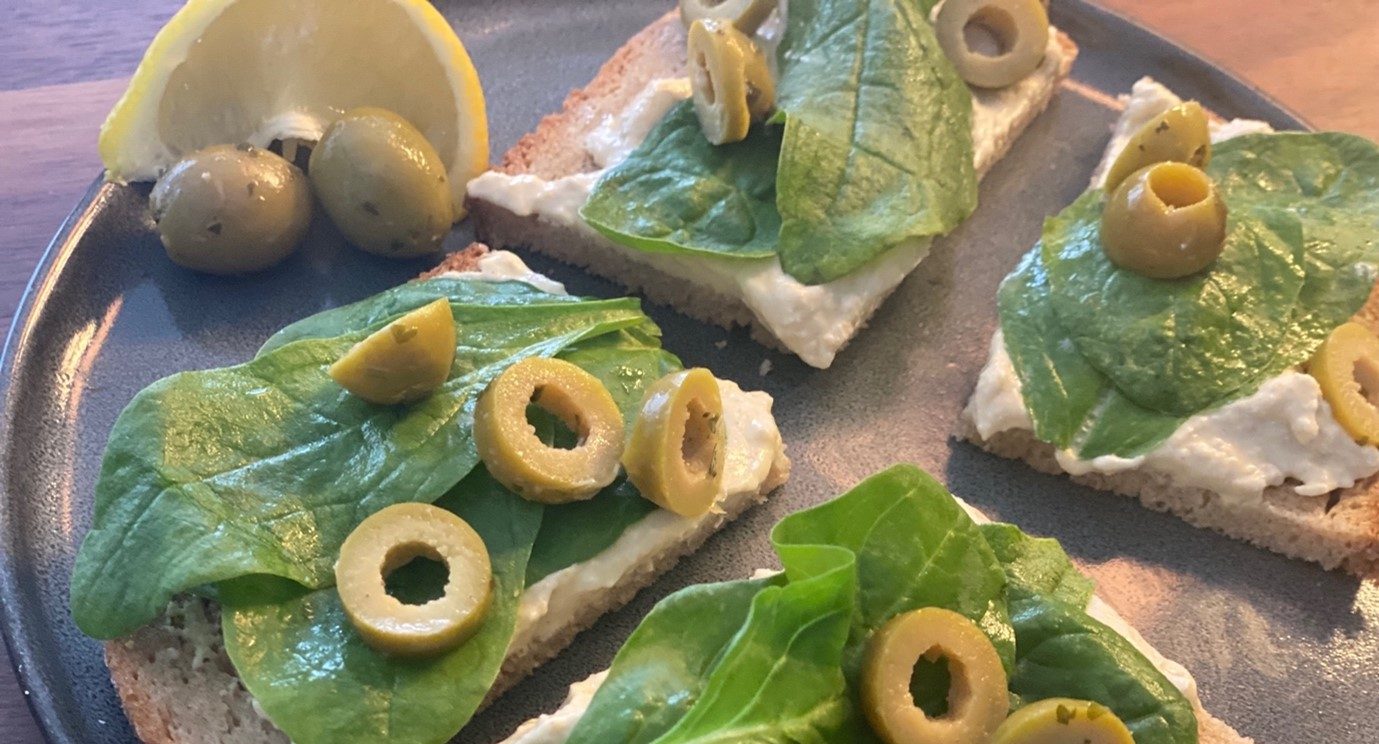 Hummus, Olive & baby spinach open sandwich on rye